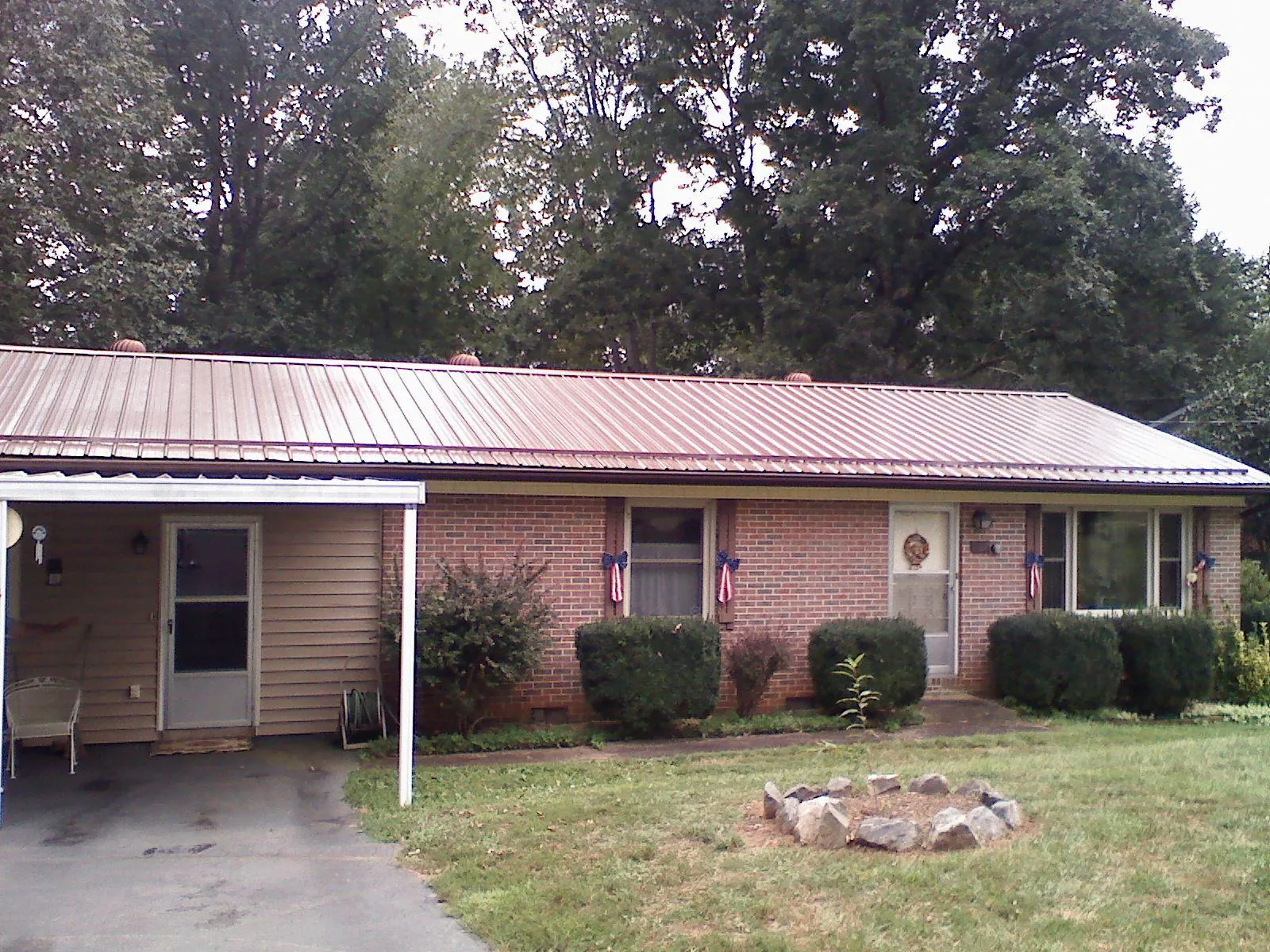 Bronze metal roof and carport on a brick ranch home — Roof Repair work by our crew in Dunfermline
